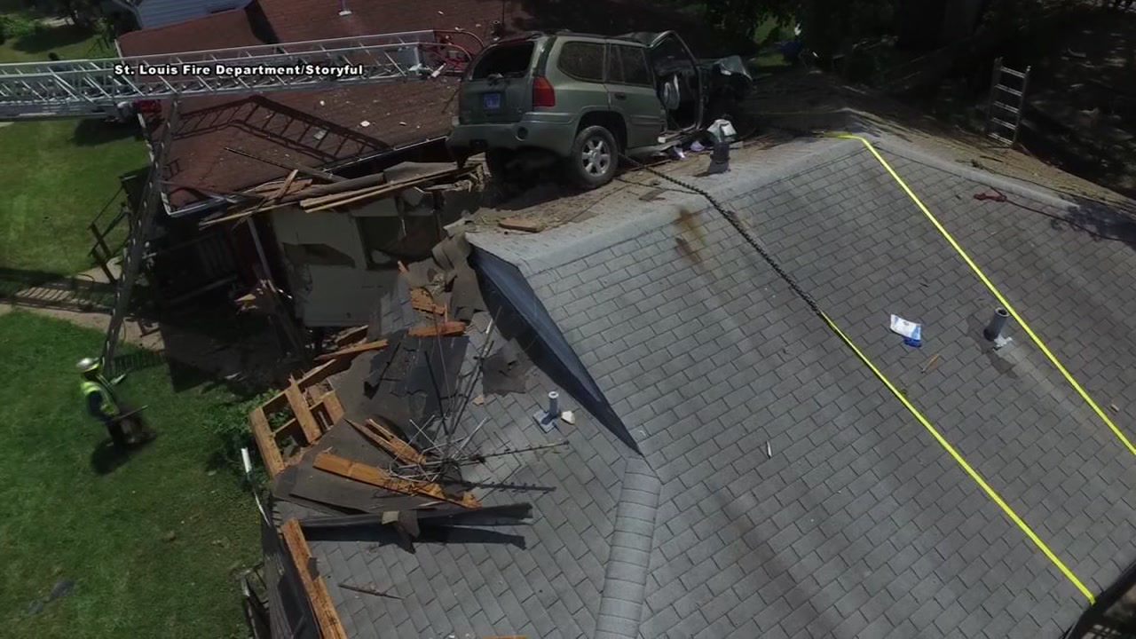 SUV goes airborne and lands on house